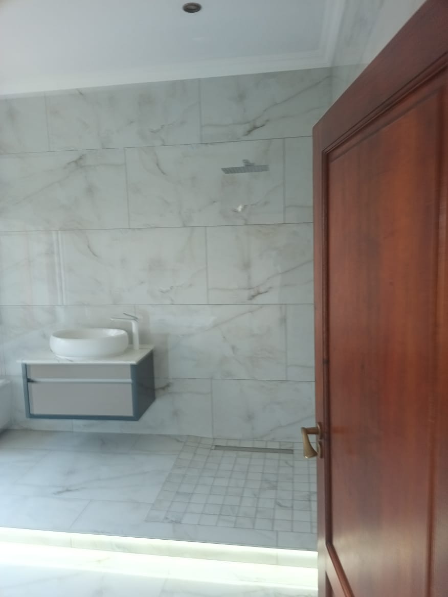 Marble Walk-In Shower & Floating Vanity