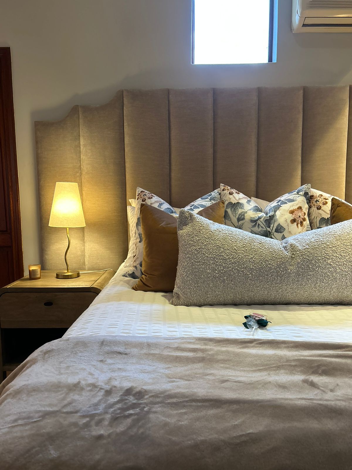 Channel-Tufted Headboard with Brass Lamps