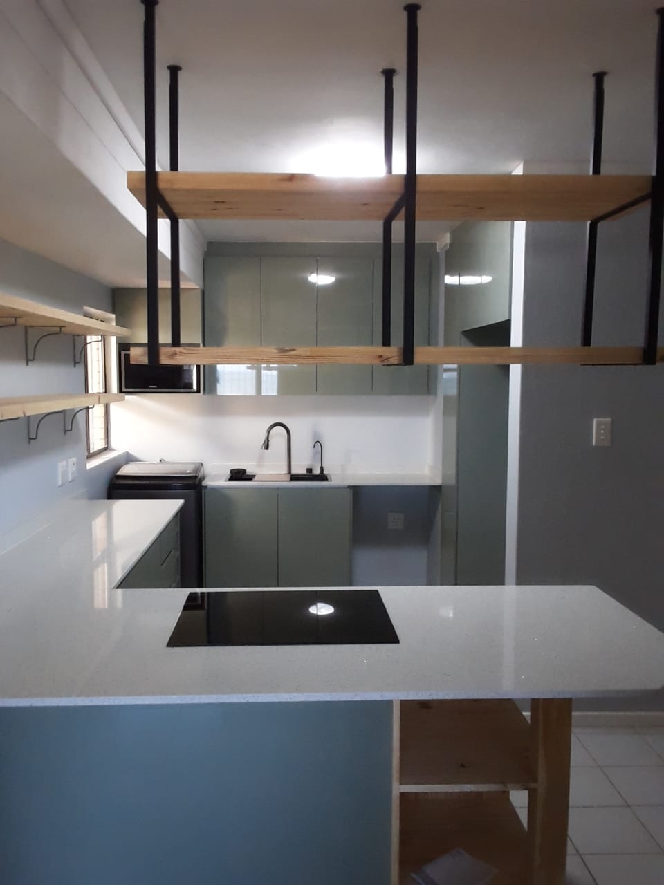 Modern Sage Kitchen with Suspended Shelving