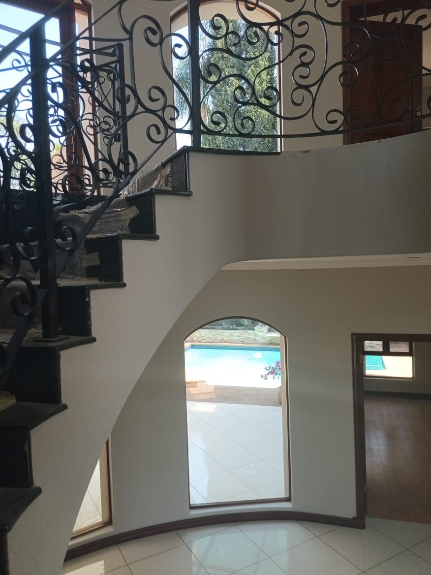 Wrought Iron Spiral Staircase & Arched Window