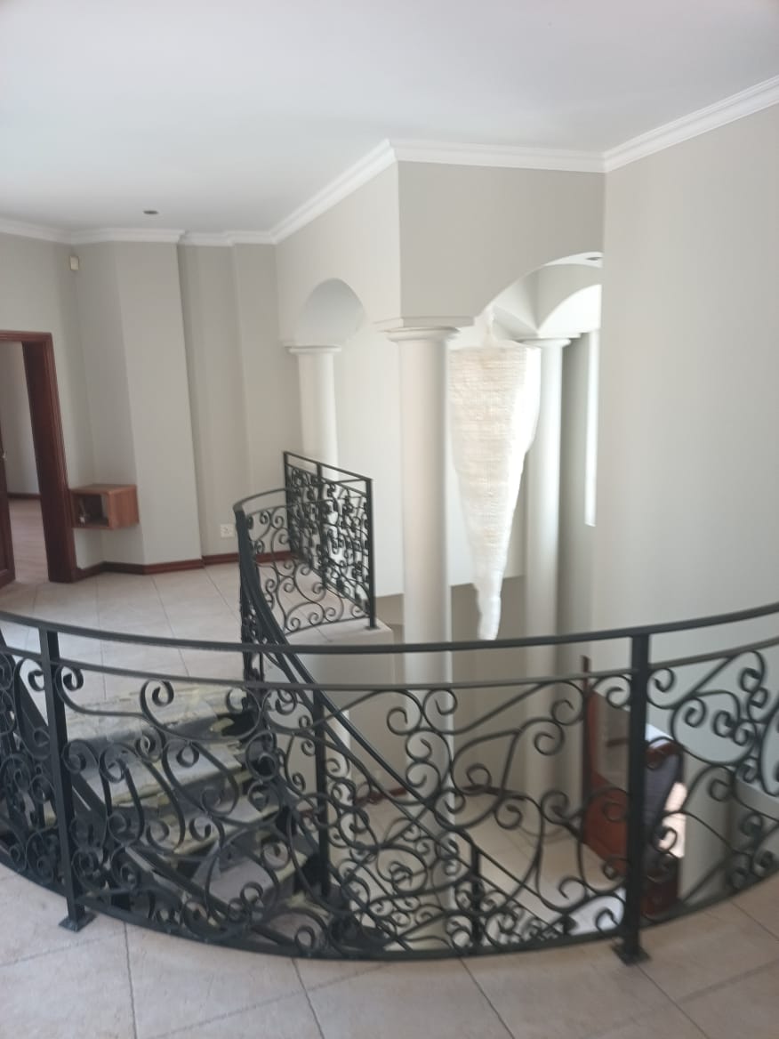 Wrought Iron Staircase & Roman Column Foyer